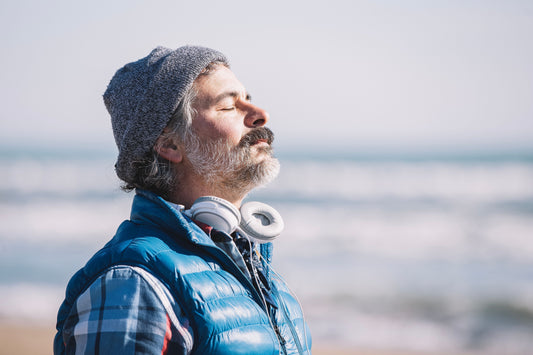 A man standing on the beach and breathing in