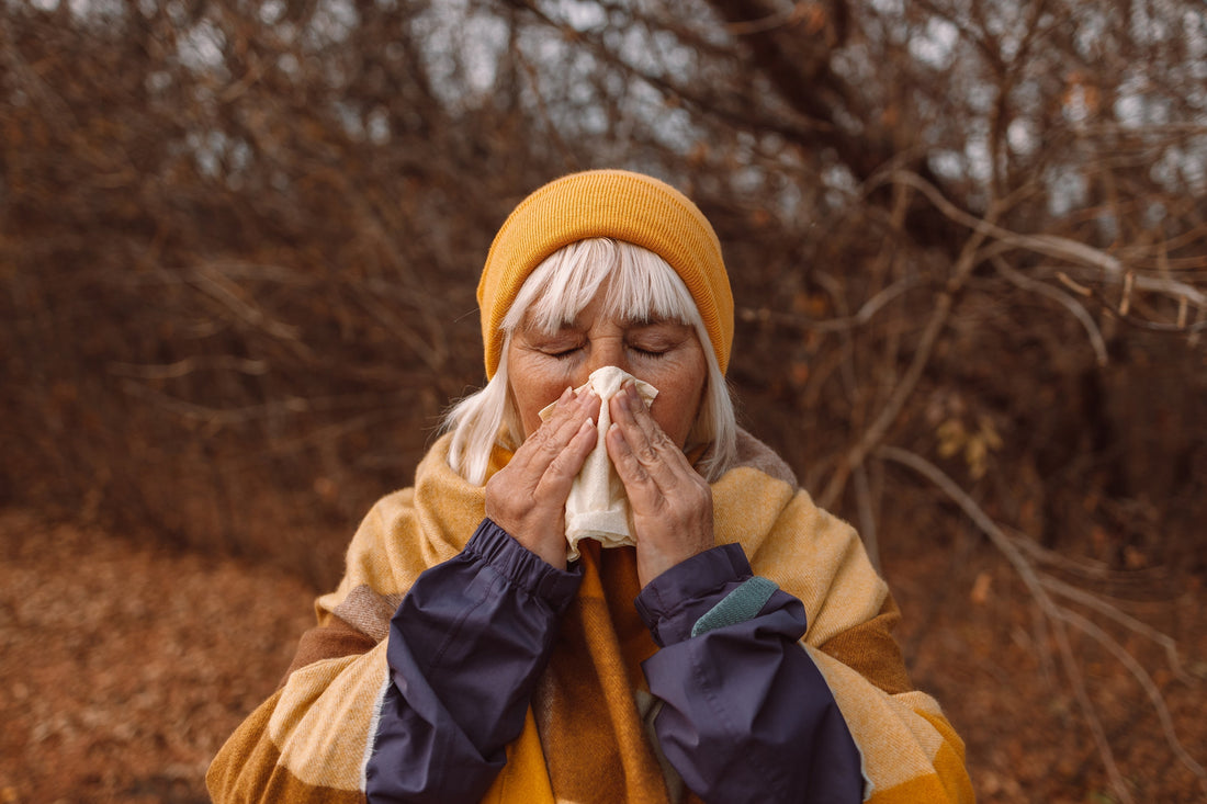 Woman sneezing outdoors