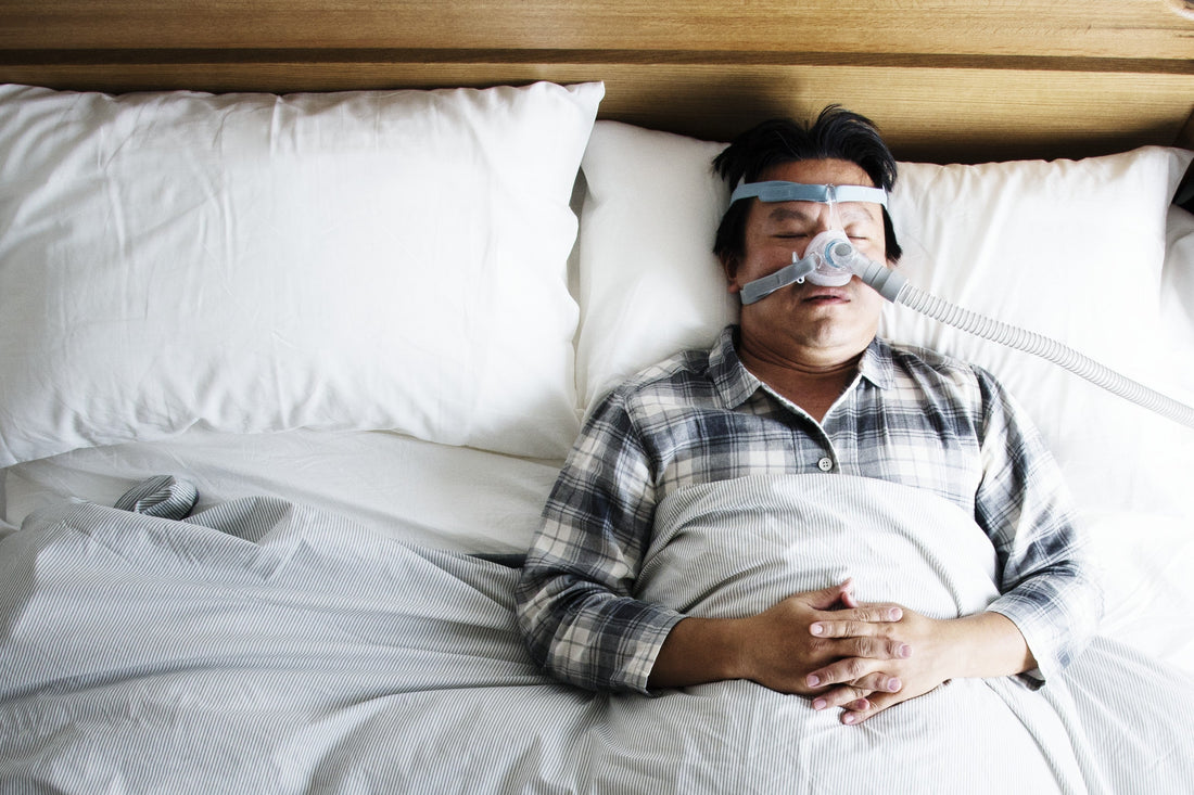 A person sleeping with a CPAP mask