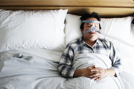 A person sleeping with a CPAP mask